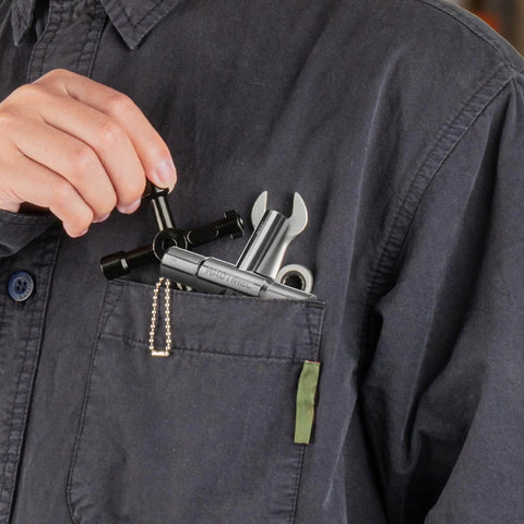 Person placing 5 Piece 4 Way Sillcock Water Key Tool Set For Faucets And Spigots Includes 1/4 9/32 5/16 11/32 Inch Keys in pocket.