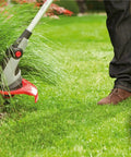 Heavy Duty Square Trimmer Line Spool.095 Inch By 1280 Ft With Built In Cutter Orange 5 Pound Pack For Gas And Electric String Trimmers That Cut Through Heavy Weeds And Thick Grass Fast, shown in use on thick grass.