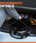 Person placing Lit Propane Fire Pit Smokeless 58000 BTU 19 Inch Outdoor Portable Fire Table with lid in car trunk