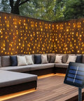 Solar Curtain Lights Outdoor 200 LED Set, 13Ft By 3.3Ft Waterproof String Lights With Auto On Off, 8 Modes, Warm White Glow on patio wall