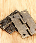 Two Pack Cabinet Door Hinges 36 By 23 MM for Wooden Boxes showcasing decorative brass design on wood surface
