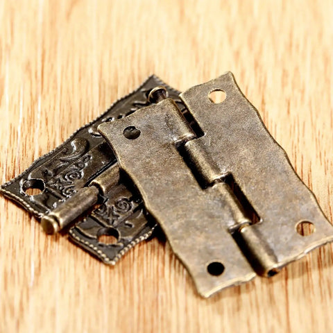 Two Pack Cabinet Door Hinges 36 By 23 MM for Wooden Boxes showcasing decorative brass design on wood surface