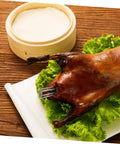 Stainless Steel Peking Duck Keeping Tool for even cooking shown inside roasted duck on lettuce with bamboo steamer