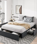 Full Size Platform Storage Bed Frame With Three Smooth Rolling Drawer Pulls Upholstered In Dark Grey Linen Fabric Over Heavy Duty Metal Supports in a modern bedroom.
