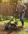 Person using Powerful 13.5 Amp Electric Tiller Cultivator With 18 Inch Wide Tilling, 6 Steel Tines for garden soil