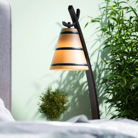 Wright 1 Light Table Lamp in Oil Rubbed Bronze Finish with amber shade in home office setup with plants, cozy lighting.