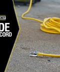 Heavy Duty Outdoor Extension Cord 100 Ft, 10 Gauge, Three-Prong T-Blade, Lighted End, Weather Resistant Yellow Jacket on pavement