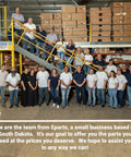 Team of employees standing and on a staircase in a warehouse with shelves of boxed products