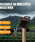Grab-And-Go Portable Solar Fence Energizer with 10 Mile Range, 0.16J Output, Auto Night Mode mounted on a fence post in rain