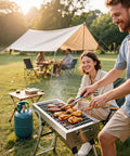 Outdoor grilling scene with a smiling couple using a grill connected to a propane tank via a six foot propane regulator stainless steel braided hose with gauge.