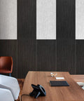 6 Pack Acoustic Wall Panels 47.2 By 23.6 Inches Black Sound Proof Panels mounted on a textured wall in an office setting.