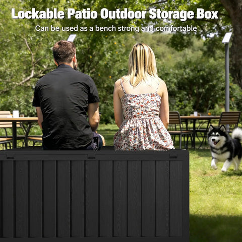 Two people sitting on a 75 Gallon Outdoor Storage Box Weatherproof And Lockable For Patio Cushions, Garden Tools, And Outdoor Gear Black