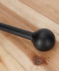 Close-up of 135 Degree Universal Hand Gear Shifter Lever for ATVs and Quad Bikes in black ergonomic design on wood surface