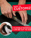 Person cutting Magnet Receptive Ferrous Sheets With Strong Peel And Stick Backing Flexible Rubber Magnetic Sheets with utility knife