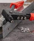 Heavy Duty Pop Rivet Gun Kit Workhorse with 120 pieces rivets and 4 interchangeable heads pictured on metal surface