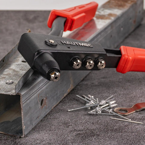 Heavy Duty Pop Rivet Gun Kit Workhorse with 120 pieces rivets and 4 interchangeable heads pictured on metal surface