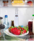 Digital Wireless Fridge And Freezer Thermometer With Alarm Dual Readouts For Home And Restaurants Max And Min Temperature Recall Easy To Read LCD Display Magnetic Backing Wall Mount Or Countertop Use inside a fridge among strawberries and bottles