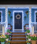 Ultra Long 168Ft 600 LED Cool White String Lights decorate blue porch with flowers and wreath, creating cozy ambiance