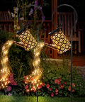 Two Pack Solar Watering Can Lantern Lights with Bendable Copper Fairy String Lights in garden at night, warm glow, ground patterns.