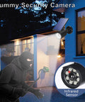 Dummy security camera with infrared sensor mounted on house, simulating real surveillance to deter intruders at night.
