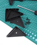 Four Pack Corner Brackets 66mm by 66mm right angle shelf braces with screws on a green cutting mat