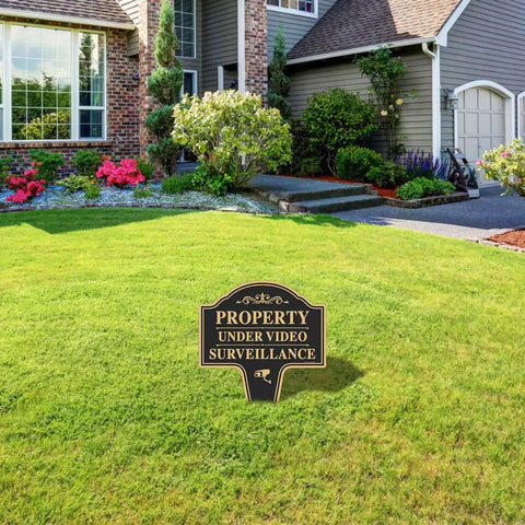 Heavy Duty Property Under Video Surveillance Sign For Outdoor Yard Warning 2 Pack 14 By 10 Inch in grassy yard setting.