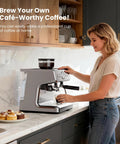 Woman using a Game Changing Espresso Machine With Built In Grinder And 20 Bar Pressure at a kitchen counter.