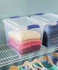 Heavy Duty Clear Storage Bins 2 Pack With Tight Blue Latches, clear containers stacked with sweaters for closet organization.