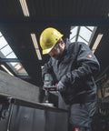 Worker using 18V Cordless Driver Drill Kit Handles Heavy Demands With Two 18V 5.5Ah Batteries And A Badass Tool Free Quick Change Chuck Featuring Killer Anti Kickback Gyro Protection For Fast Metal Work on steel.