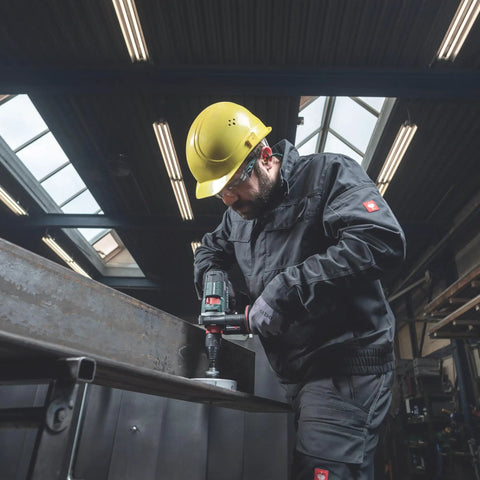 Worker using 18V Cordless Driver Drill Kit Handles Heavy Demands With Two 18V 5.5Ah Batteries And A Badass Tool Free Quick Change Chuck Featuring Killer Anti Kickback Gyro Protection For Fast Metal Work on steel.