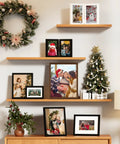 Double 4x6 Picture Frame Vertical From Engineered Wood With Plexiglass Bifold Photo Frame For Tabletop Display Holds Two 4x6 Photos In A Dope Black Finish That Fits Any Desk Or Shelf displayed on a wooden shelf with holiday decorations