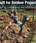 5 Lb Steel Pick Mattock With 36 Inch Fiberglass Handle breaking ground in a garden with visible soil and roots