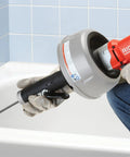 Professional Grade Pneumatic Air Powered 230V Drain Cleaning Tool in use, heavy-duty design for stubborn clogs in a bathtub.