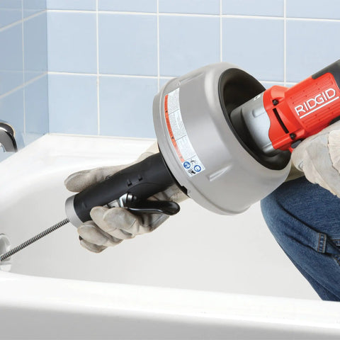 Professional Grade Pneumatic Air Powered 230V Drain Cleaning Tool in use, heavy-duty design for stubborn clogs in a bathtub.