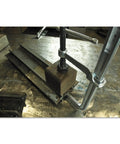 Beefy 12 Inch All Steel Bar Clamp With 2660 Nominal Clamping Force on metal workbench, heat treated for max strength.