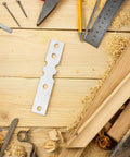 Heavy Duty Door Repair Plates 50 Pack For Iron And Wood Frames flat connecting plate on a wooden workspace with tools