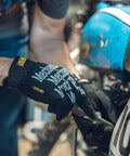 Person using a screwdriver wearing Multi Purpose Work Gloves For Outdoor Jobs With Touchscreen Capability, black, large size.