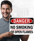 Man holding a Straight Up Danger No Smoking Or Open Flames Sign 10X14 Inches.040 Rust Free Aluminum Fire Safety Warning Plaque.