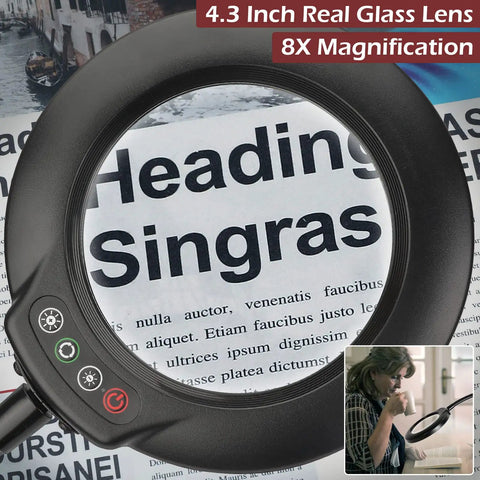 Close-up of 8X Magnifying Glass With Light Floor Lamp For DIYers showing a 4.3-inch lens magnifying text on a newspaper page.