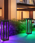 Solar Patio Floor Lamp 2 Pack Waterproof RGB Color Changing Garden Path Lights illuminating a driveway and greenery at night.