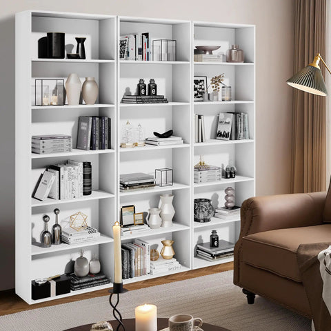Tall 71 Inch White Bookshelf With Six Open Shelves Floor Standing Bookcase For Living Room Home Office And Bedroom Super Sized Storage For Books Decor And More, filled with books and decor items against a beige wall.