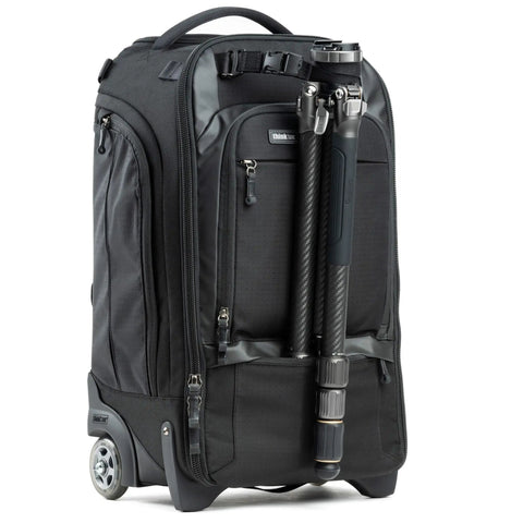 Walker Pro Rolling Camera Backpack with attached tripod, showing smooth rolling wheels, black rugged material exterior, and front pockets.