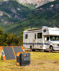 Ultra Portable 98Wh Solar Generator Kit With 60W Foldable Panel, 120W Power Station, next to RV in mountain landscape