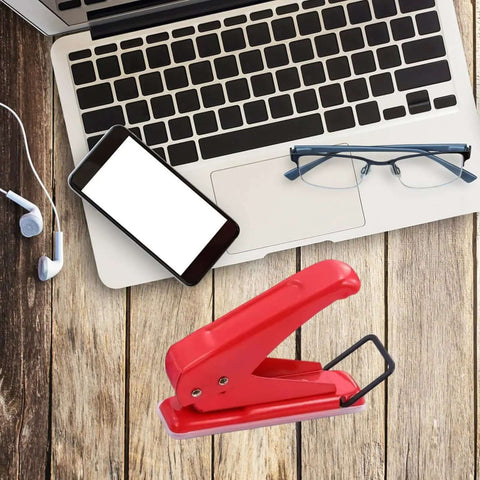 Go-To One Quarter Inch Single Hole Puncher With 20-Sheet Capacity on wooden desk with laptop and glasses