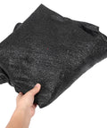 Hand holding folded trampoline shade cover sun shelter for outdoor trampolines weather resistant and rainproof canopy easy install.