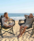 Couple relaxing on beach in ultra comfy portable hammock camping chair with adjustable backrest, Stargazer Black