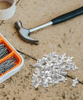 Aluminum Blind Rivets Kit 200 Piece With Dome Drive Heads scattered on a workbench with a hammer and screw organizer visible.