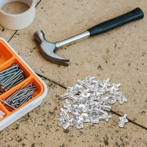 Aluminum Blind Rivets Kit 200 Piece With Dome Drive Heads scattered on a workbench with a hammer and screw organizer visible.