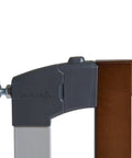 Close-up of Auto Close Modern Pressure Mounted Baby Gate For Stairs, Hallways And Doors, featuring dark wood and silver metal latch.