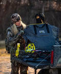 Hunter using Scent Safe Deluxe Travel Scent Bag For Hunting Gear And Clothing over truck bed outdoors